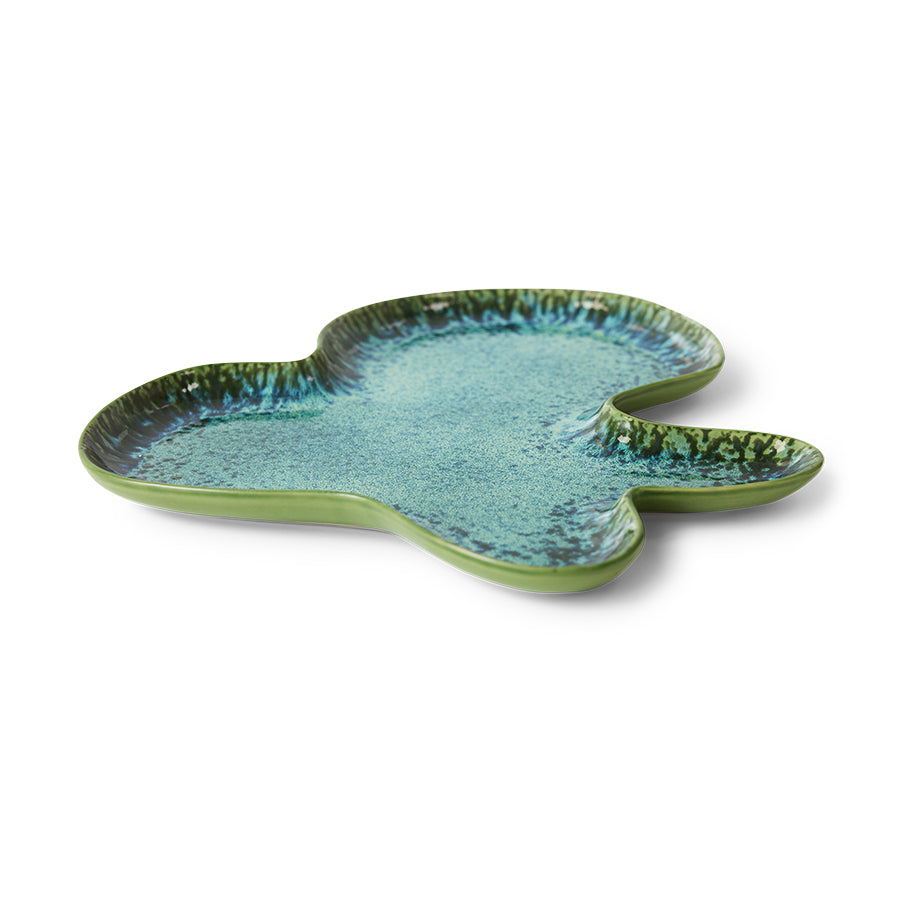 Ceramic leaf-shaped plate with a blue and green glaze on a white background