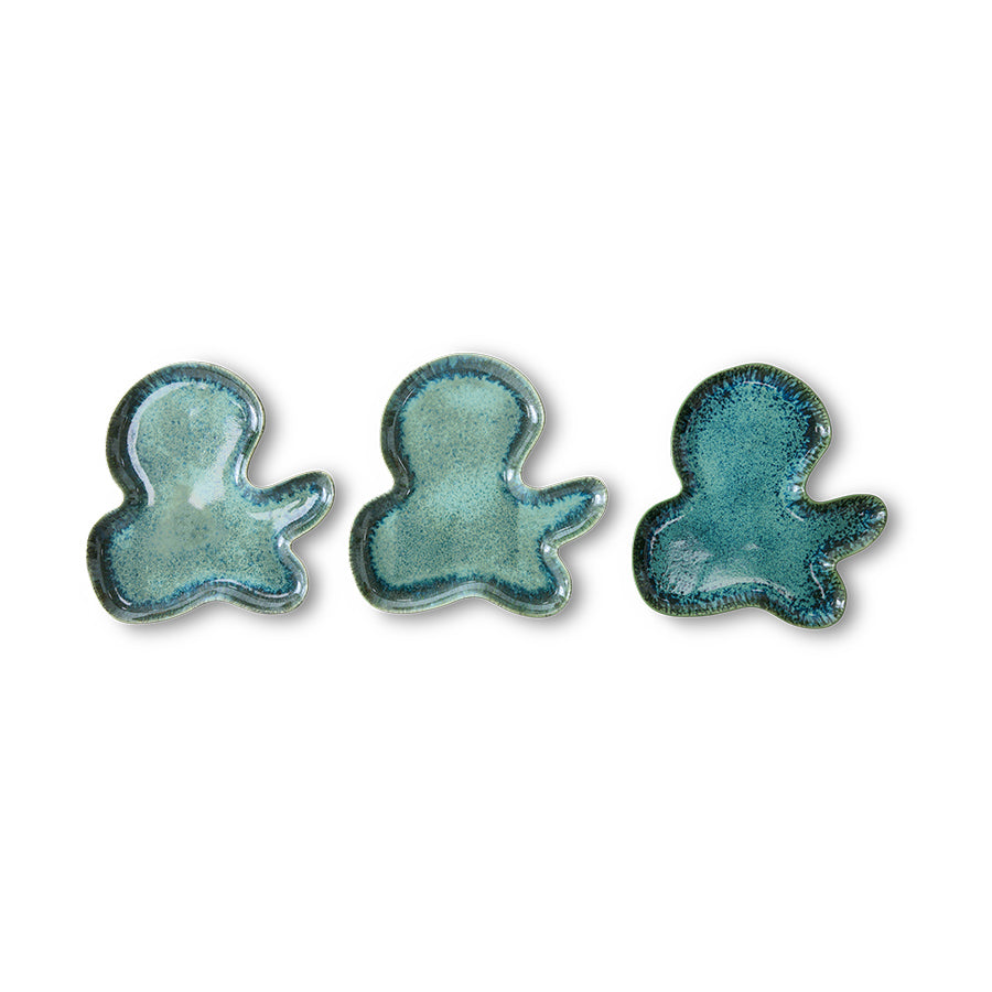 Three blue ceramic octopus figurines on a white background