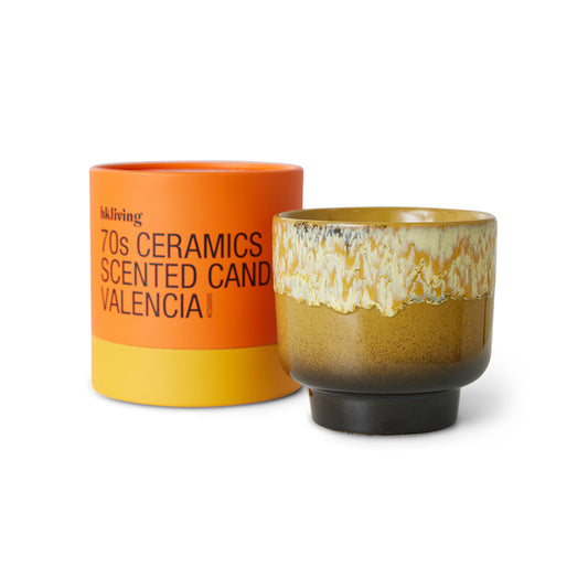 Ceramic candle with decorative packaging on a white background