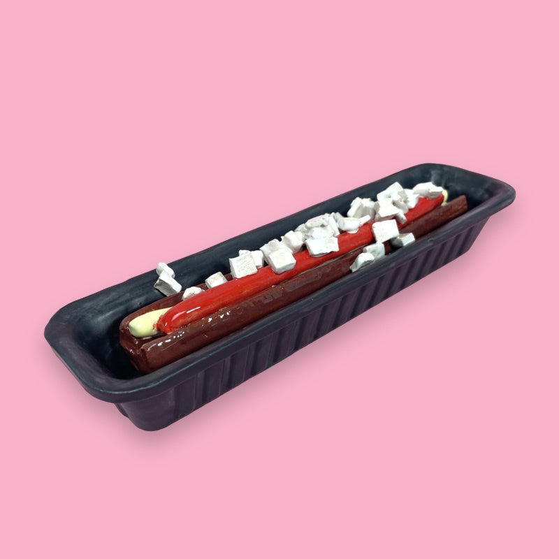 art work of a frikandel; black open container with deep fried snack, sauce and onions made of glazed pottery