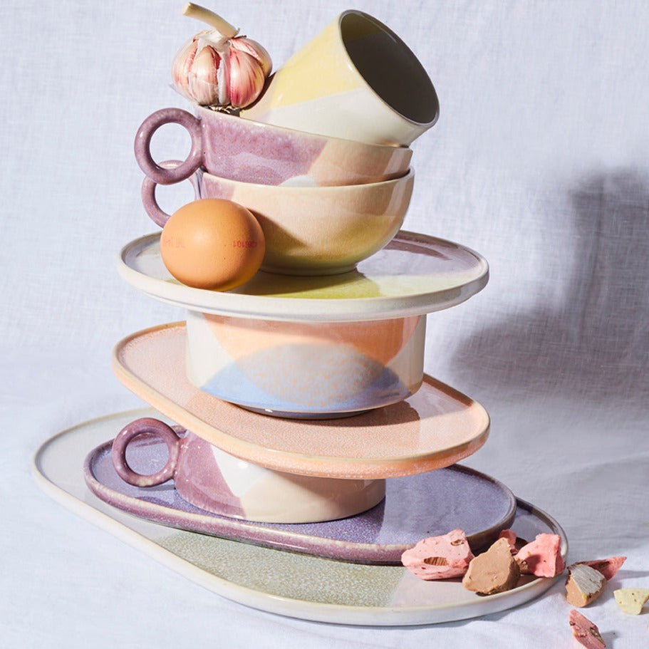 stack of pastel colored ceramics with candy