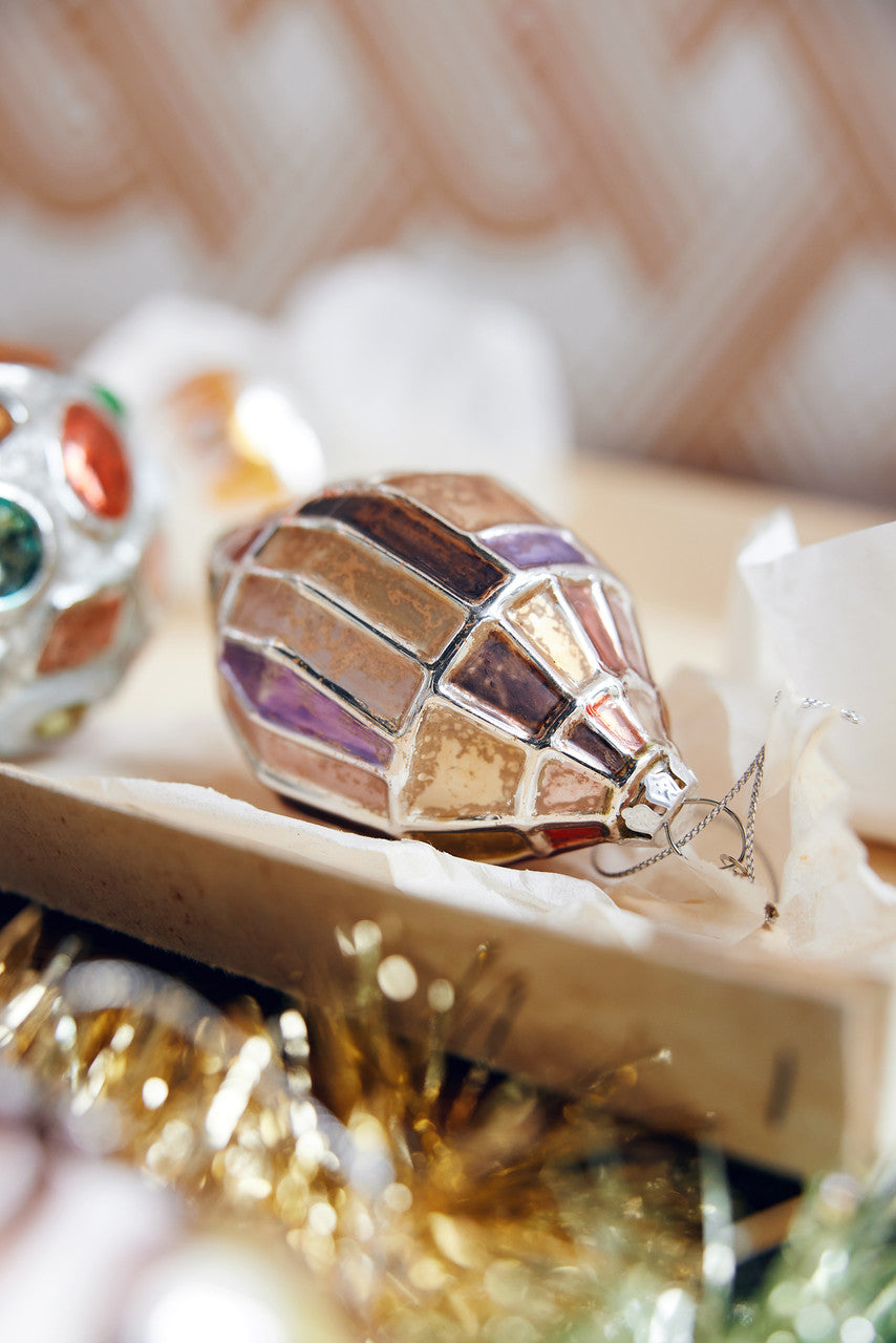 glass Christmas ornament with silver and warm colors