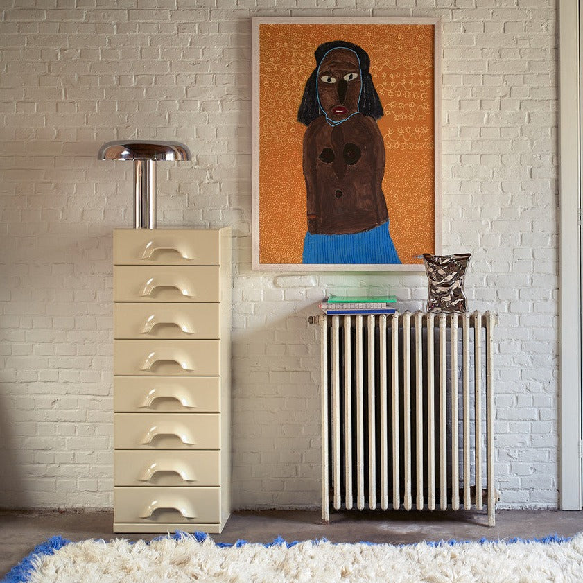 living room with large painting and silver bag of chips object vase on radiator