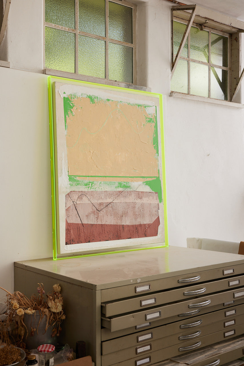 abstract painting with neon yellow frame in studio
