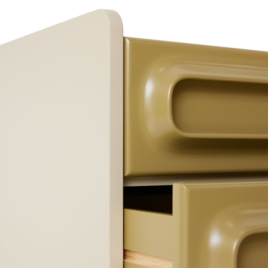 detail of retro style nightstand with two drawers in sage green with cream