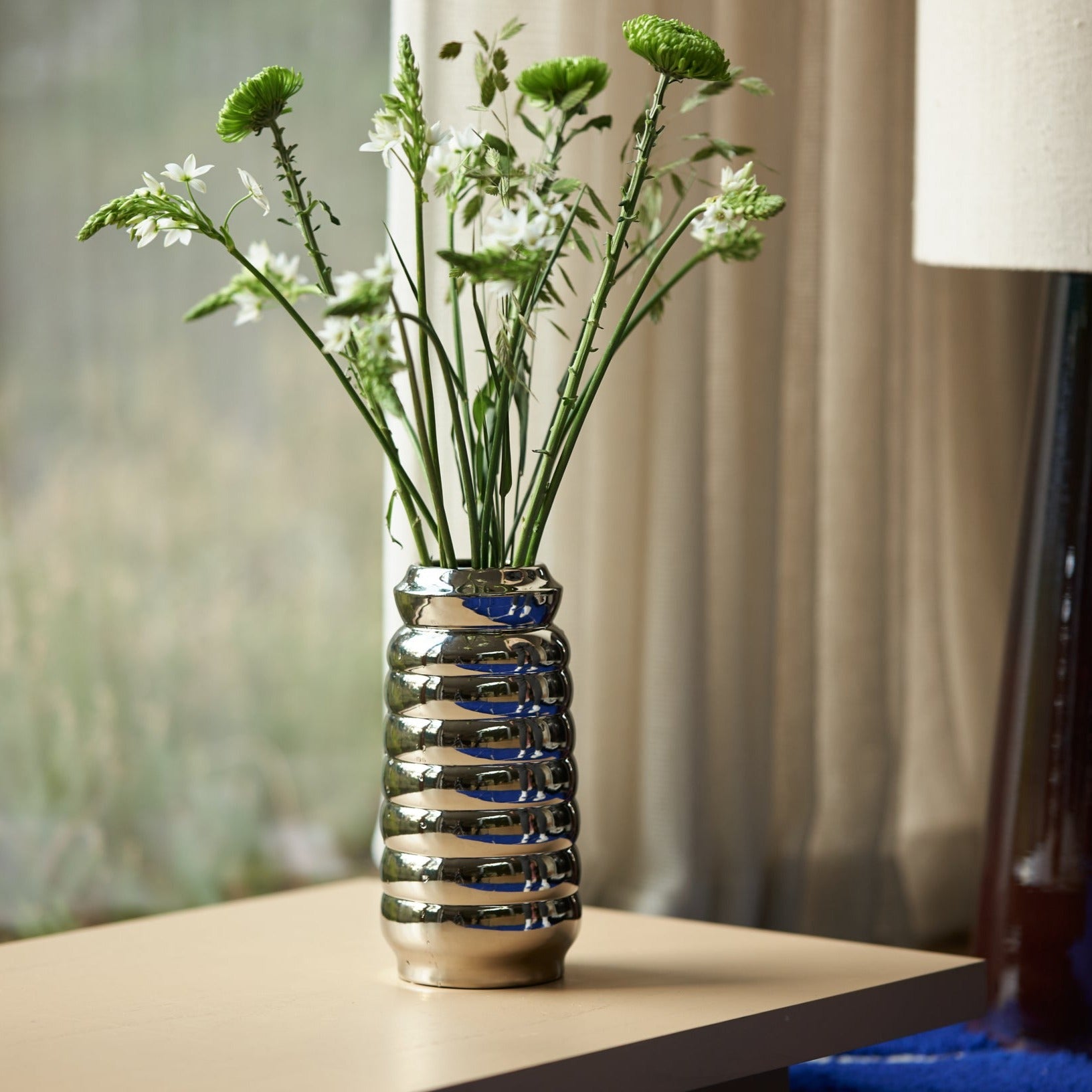 chrome ribble vase with white flowers