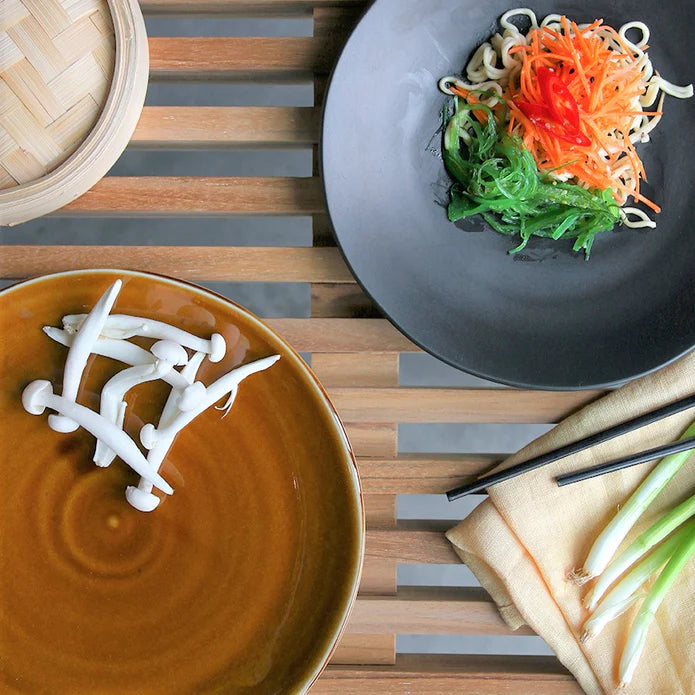 brown and black ceramic plates with food