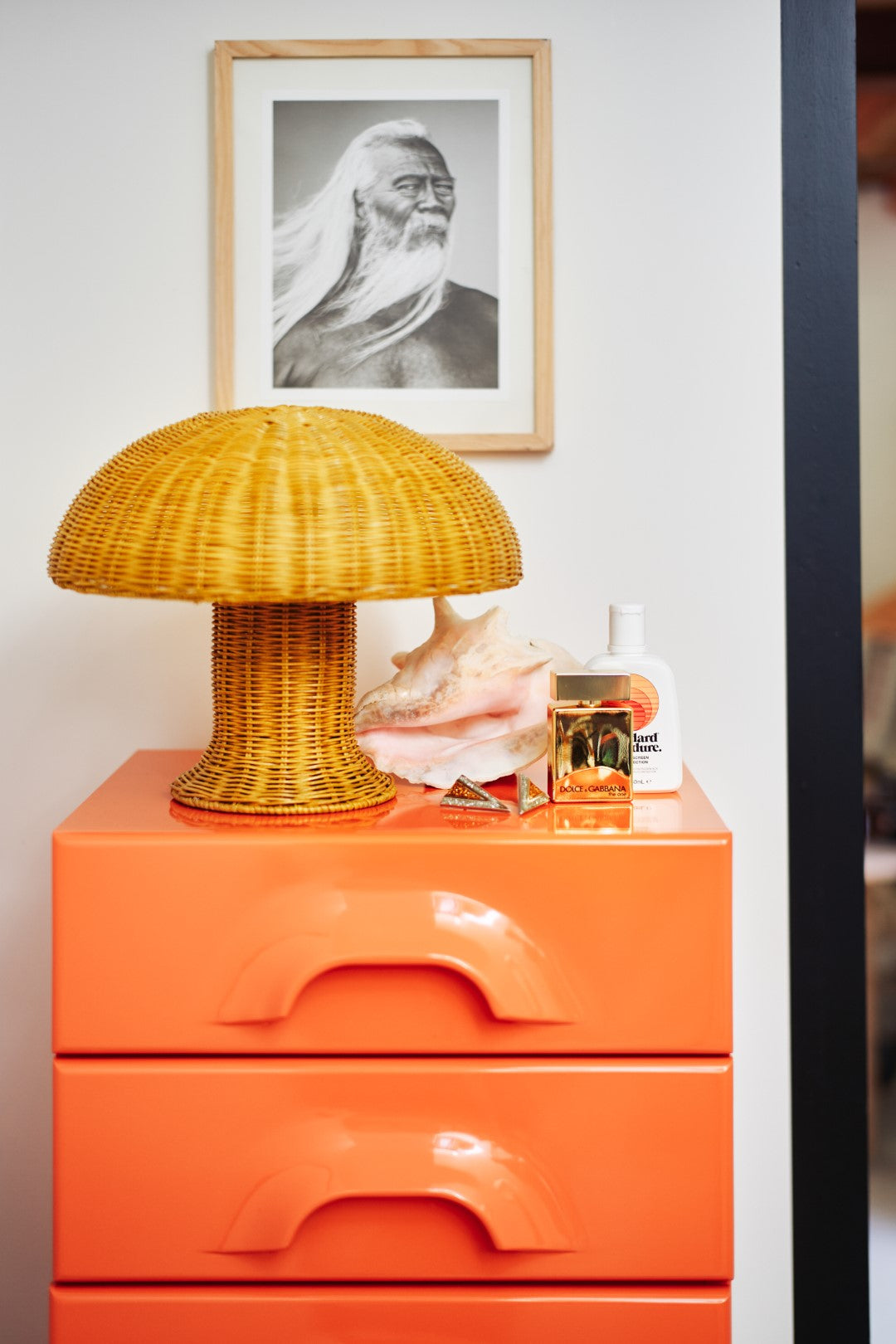 mustard yellow rattan mushroom table lamp on orange chest of drawers