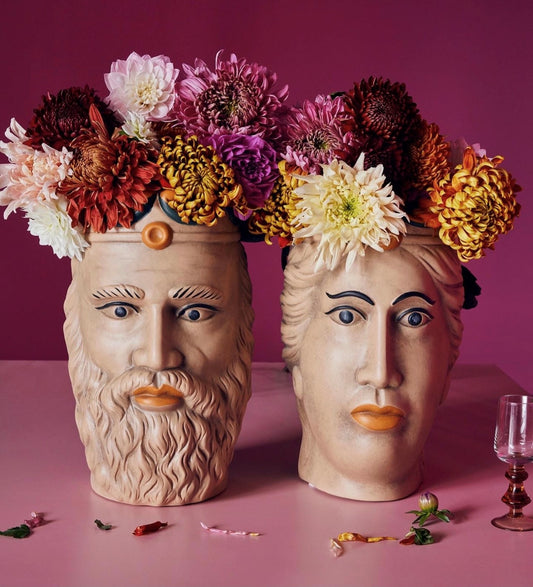 set of Moor head planters filled with flowers