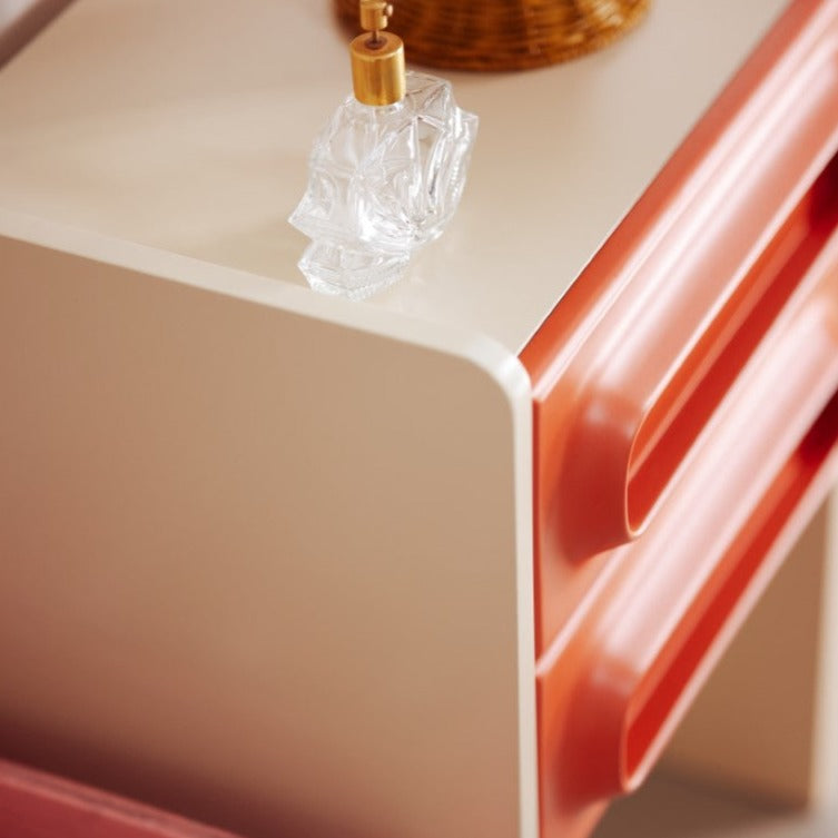 detail of cream and orange nightstand with 2 drawers