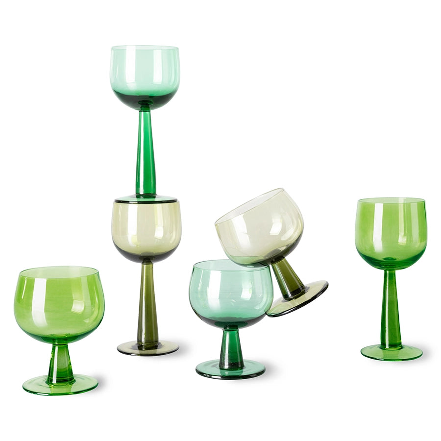 high and low stem green colored wineglasses
