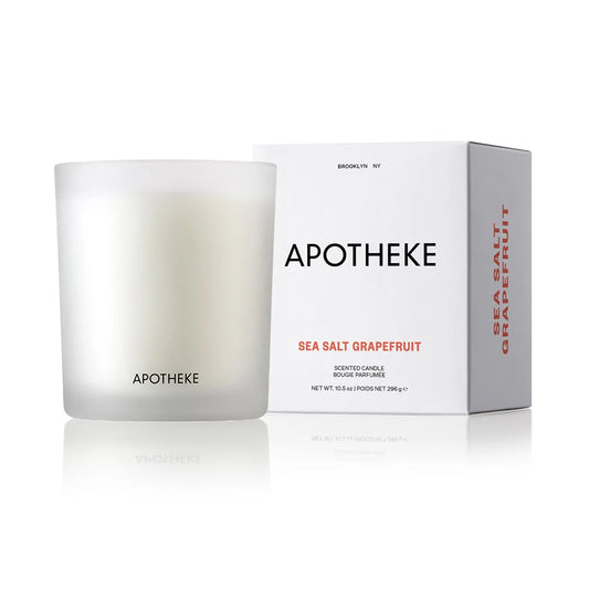 white glass vessel with scented candle and apotheke logo and box