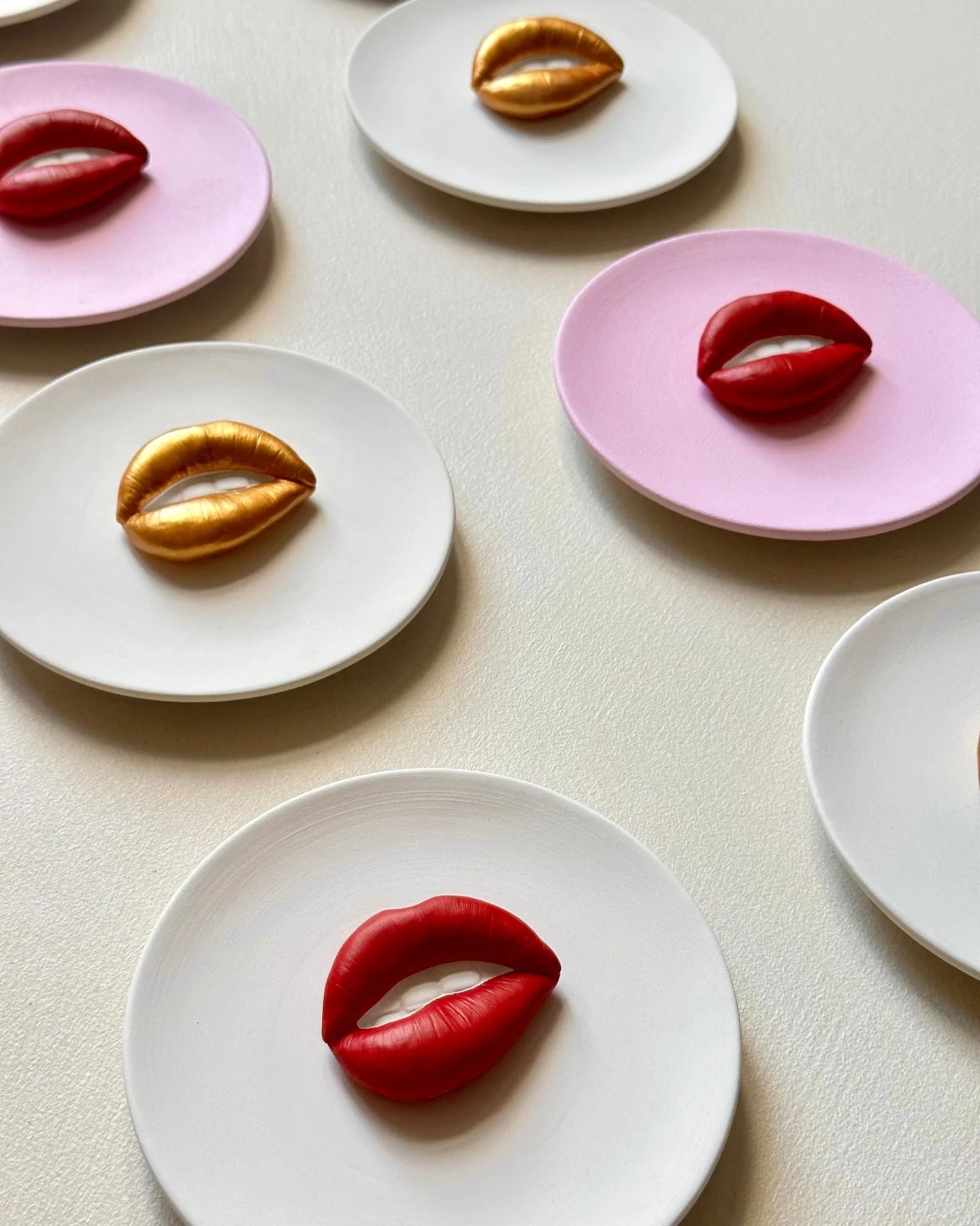 Decorative plates with lip-shaped designs on a light background