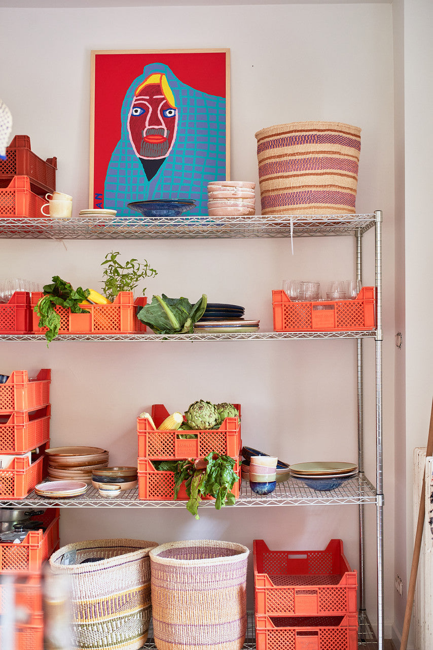 pantry with painting, orange crates and dinnerware