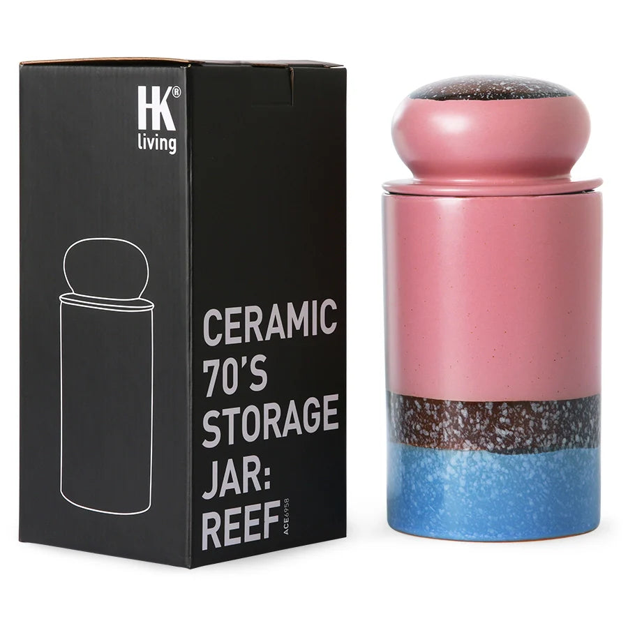 pink brown and blue storage jar with black box