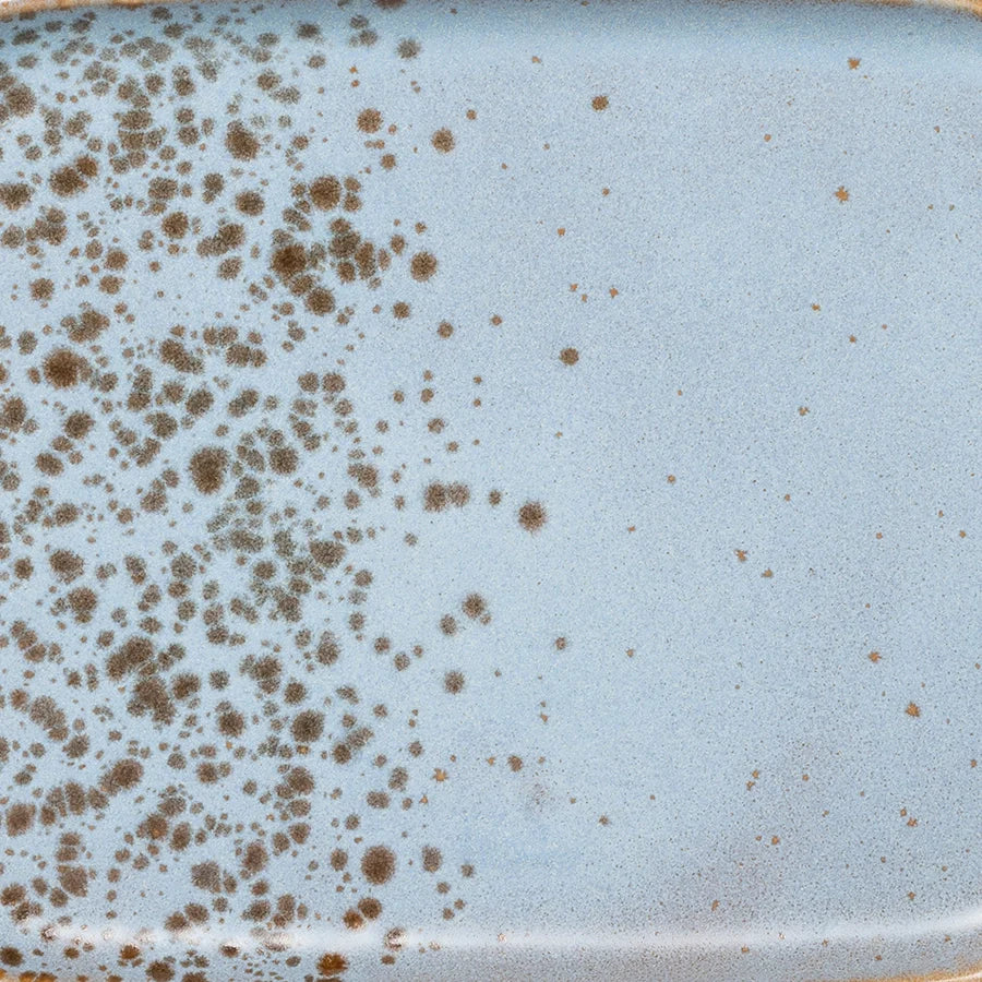 detail of reactive glaze of blue and black stoneware tray