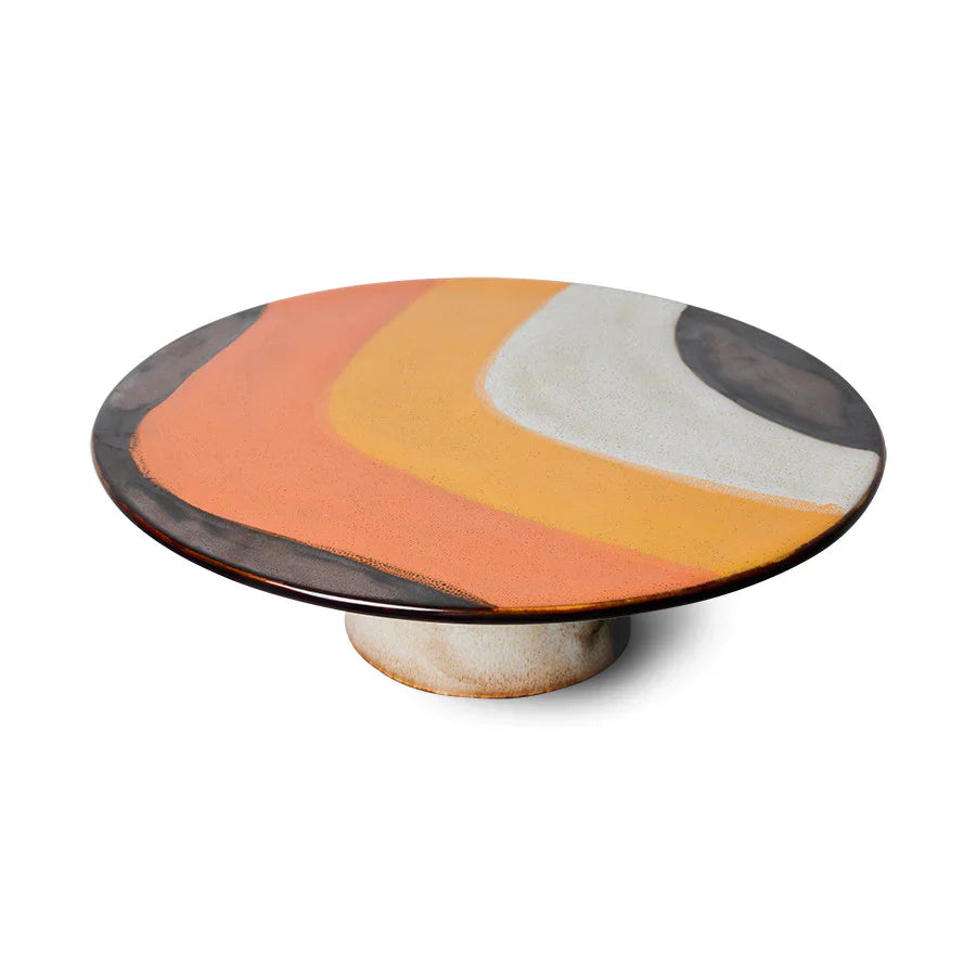 round cake stand with brown, orange and yellow retro style design glazing