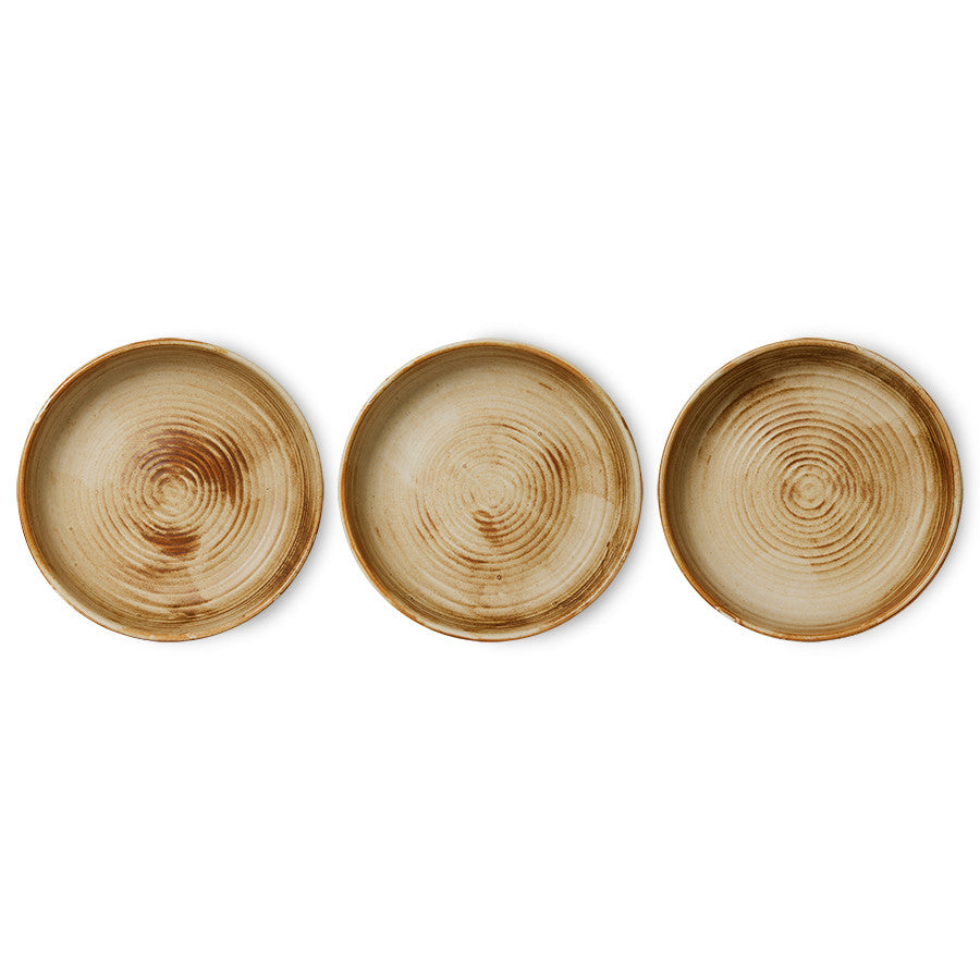 variations in finish of cream and brown round porcelain side plate