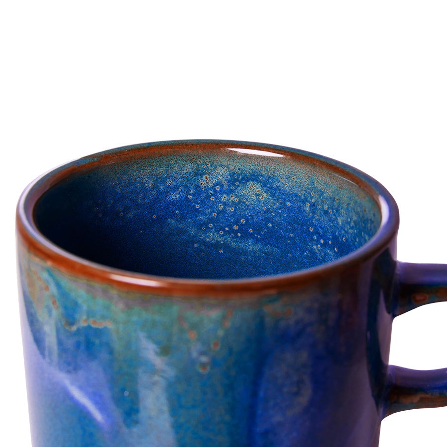 cup and saucer made from porcelain with a rustic blue glazed finish