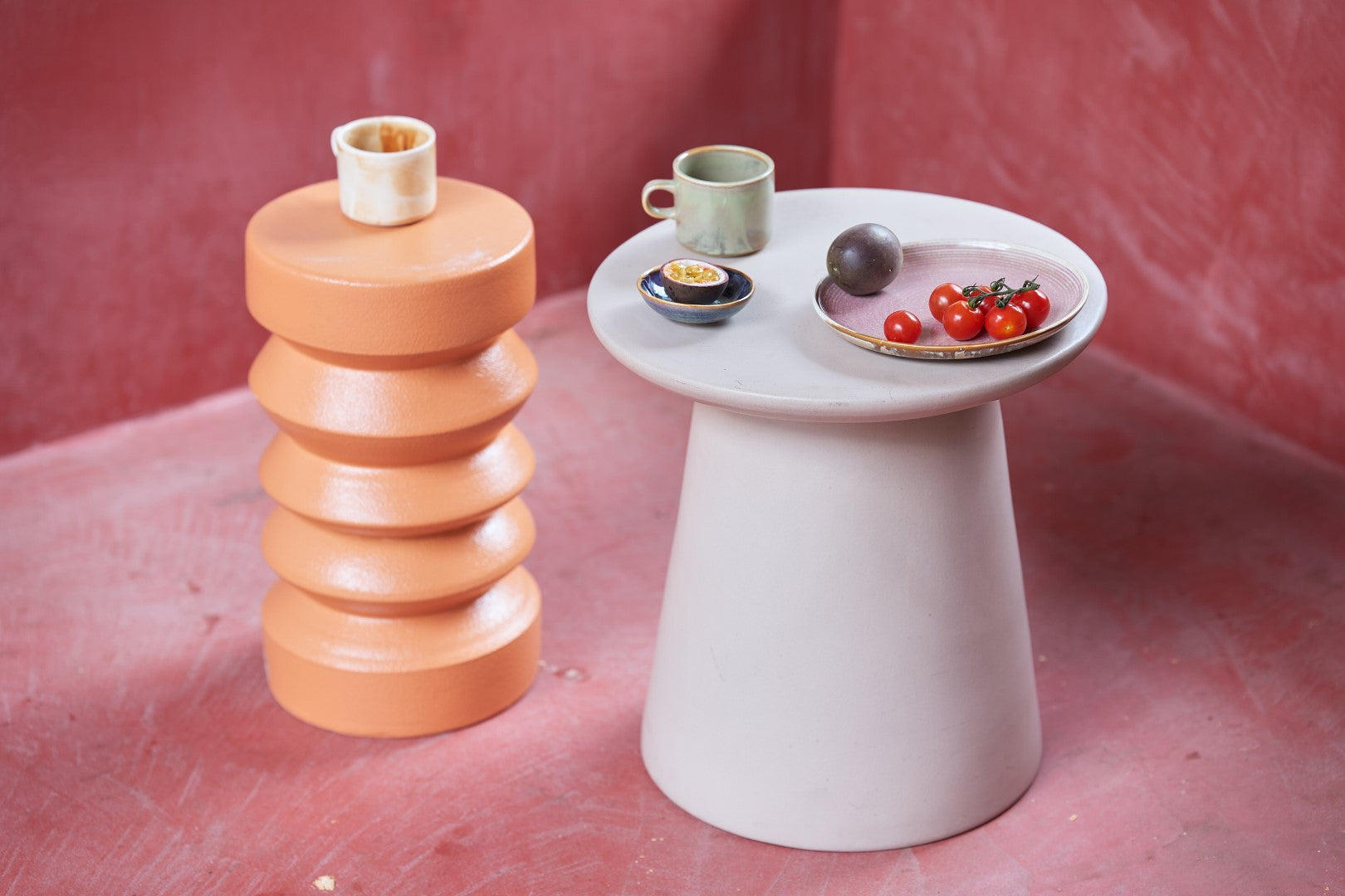 orange table with part of cream and brown cup with saucer