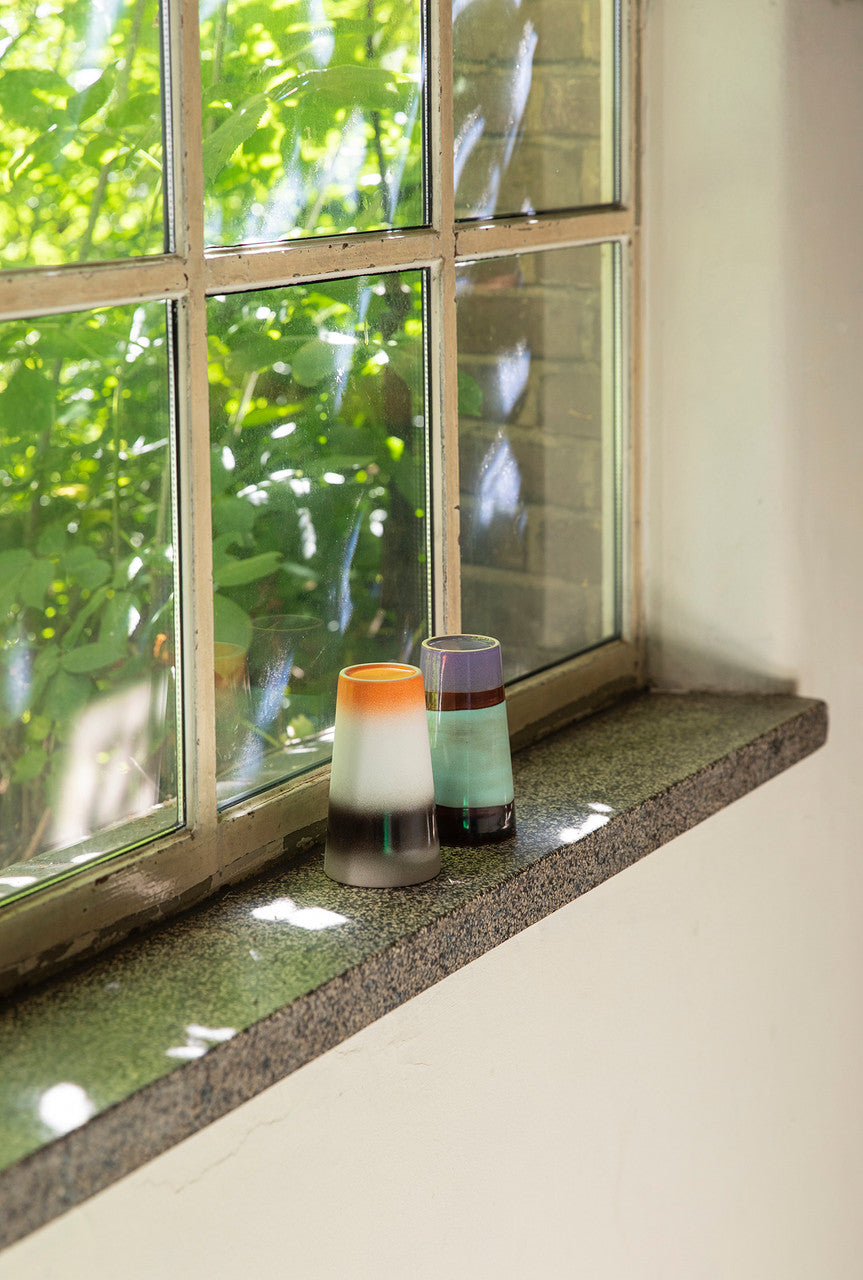 two latte mugs in a window setting