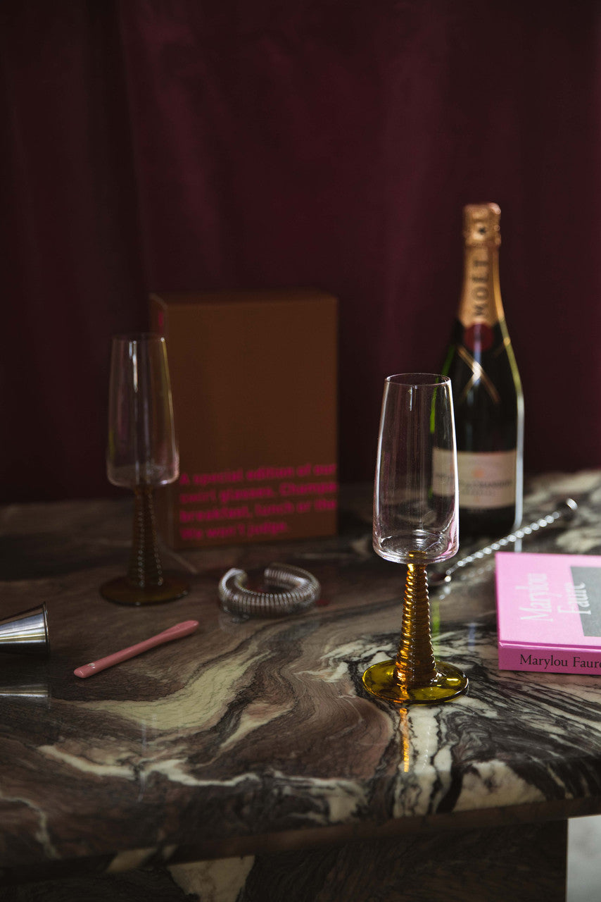 champagne glasses with ochre colored stem