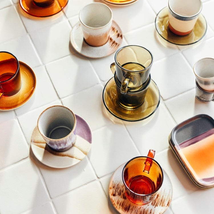 glass coffee cups in combination with stoneware saucers