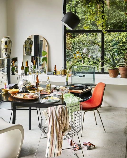 dining room with black table and metal wire dining chairs
