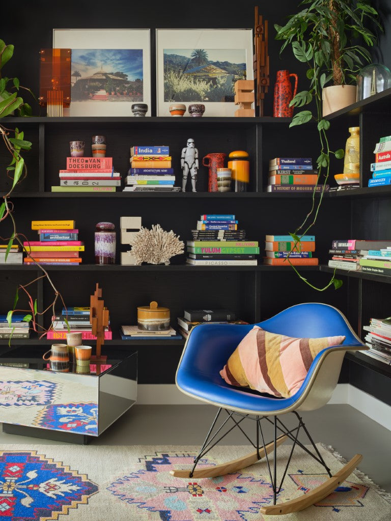 striped velvet lumbar pillow in caramel and pink tones in blue Eames chair