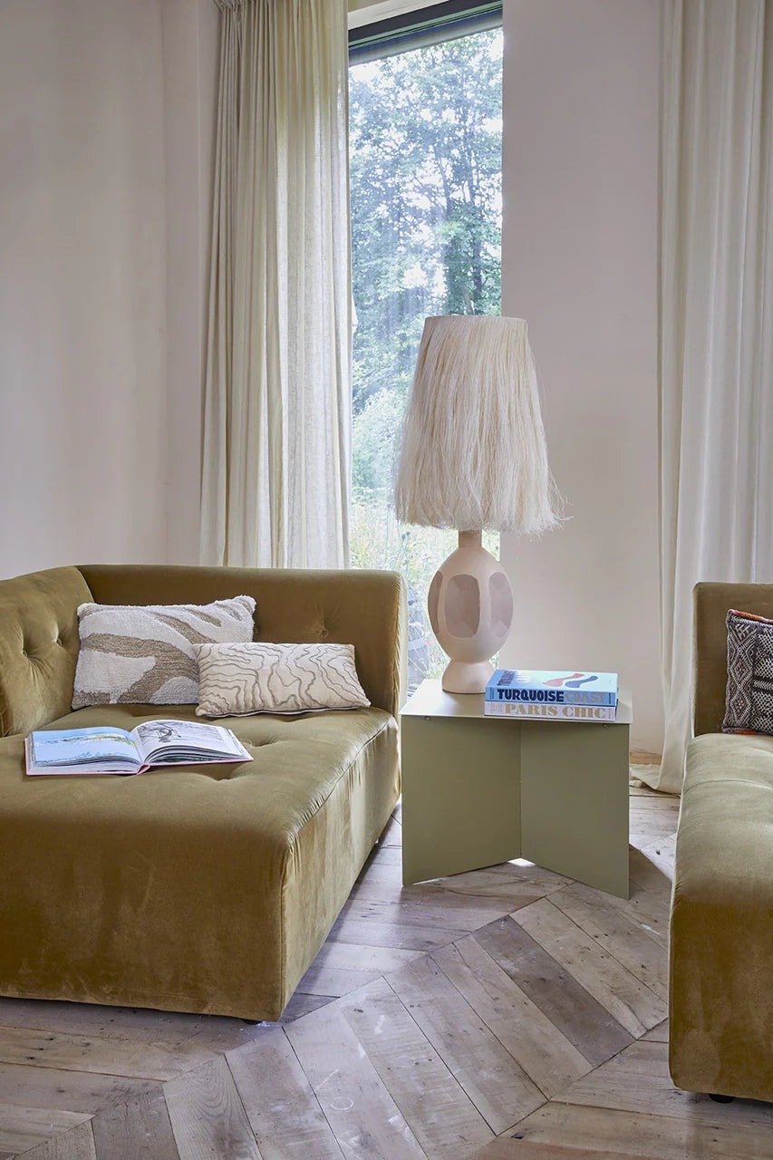 day bed in velvet with olive green metal side table and sand colored boho style table lamp with real abaca strings shade