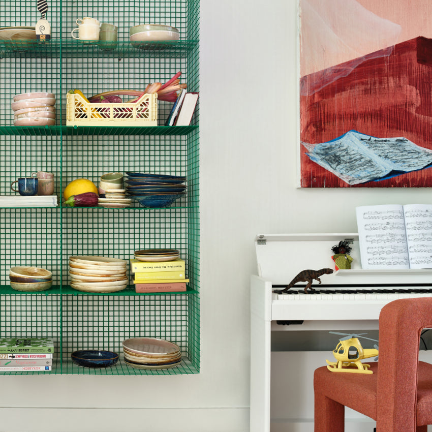 geen open shelving in dining room with chef ceramics on display