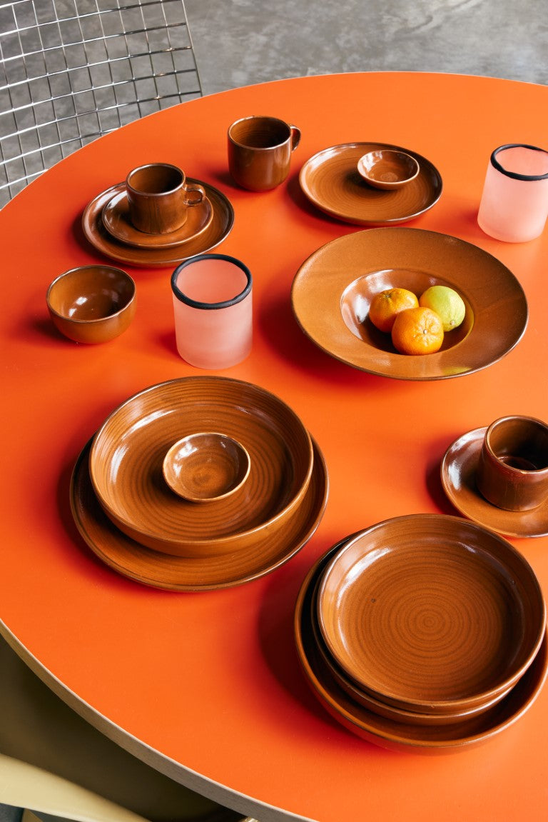 burned orange side plate on orange table