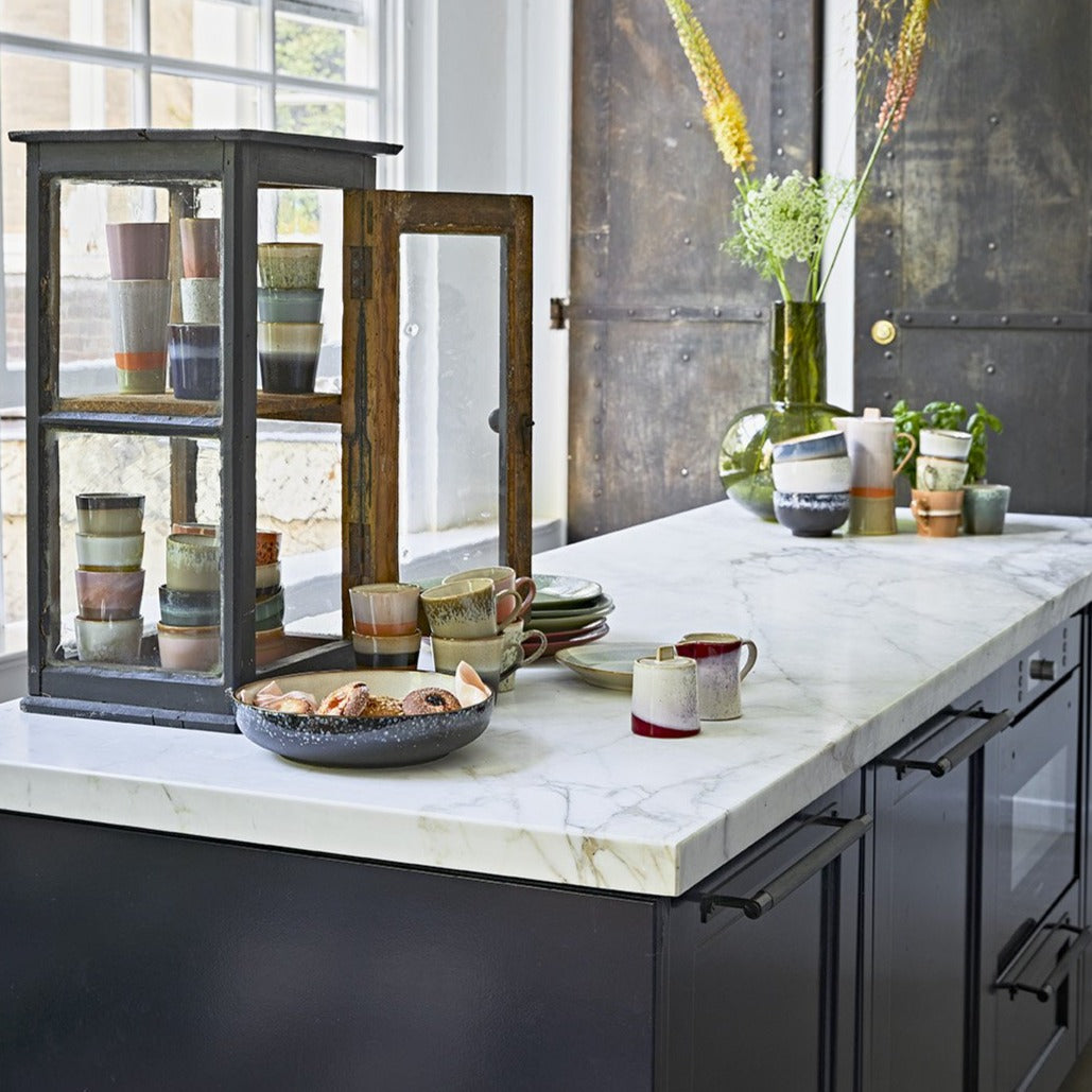 modern farmhouse style kitchen with display of ceramic bowls and cups