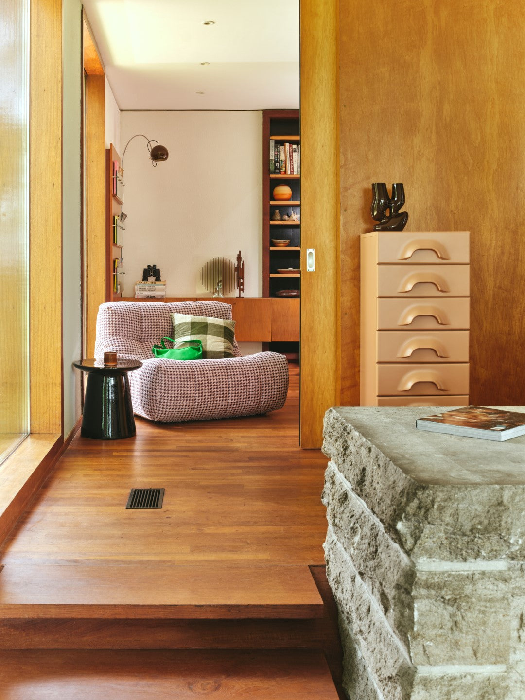 blush colored chest with 7 drawers against wooden wall in hallway