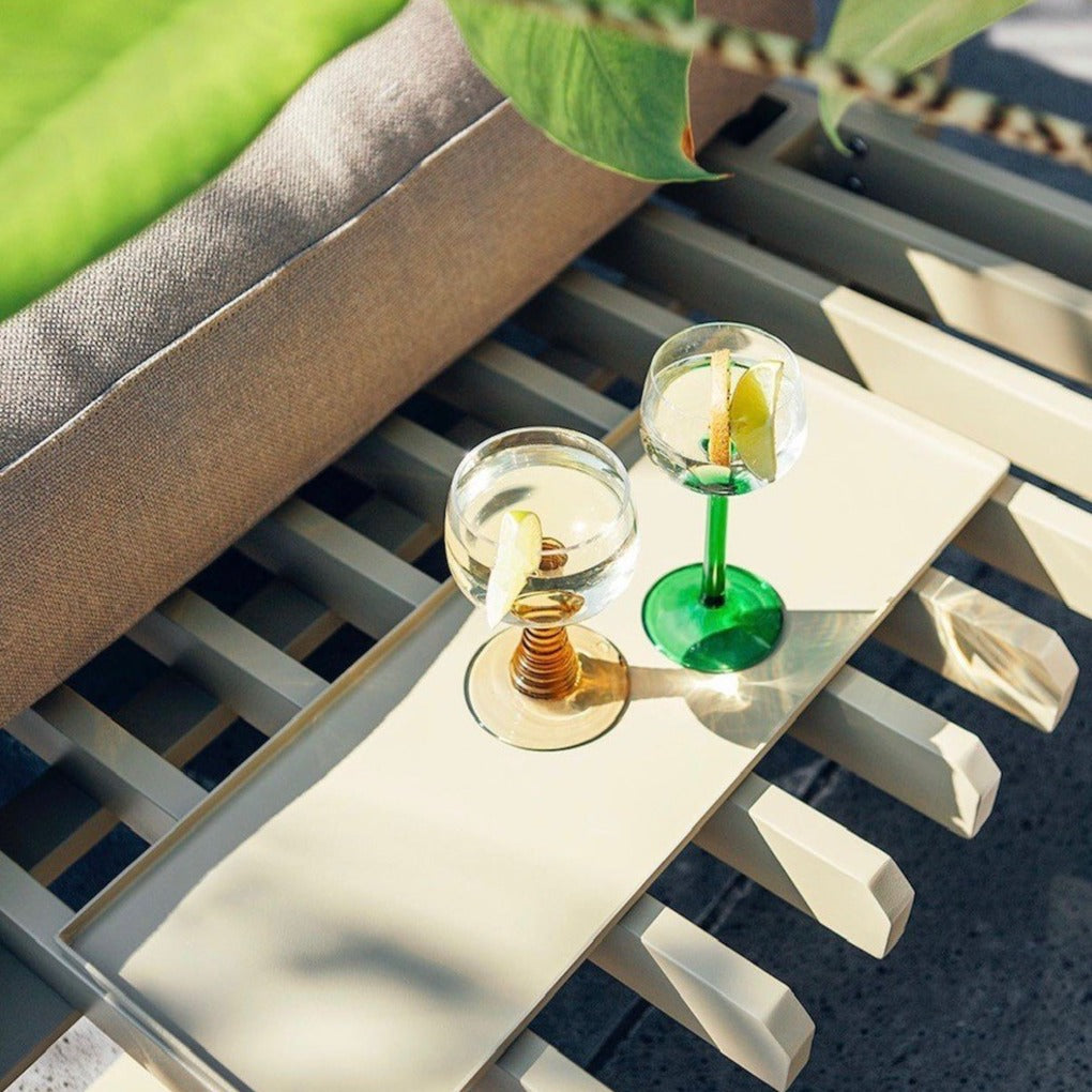 detail of aluminum tray on the olive green outdoor sofa