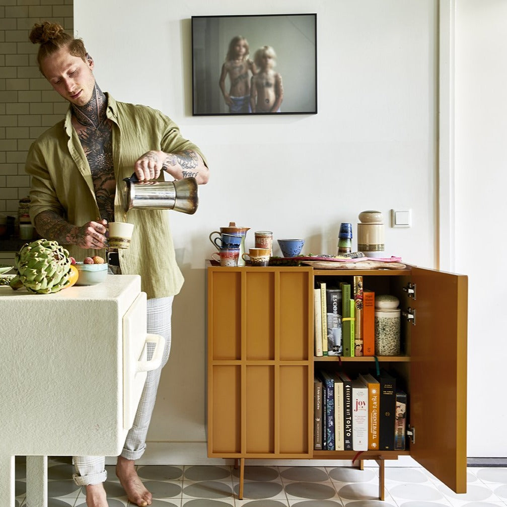 kitchen with open cabinet filled with cook books and storage jars