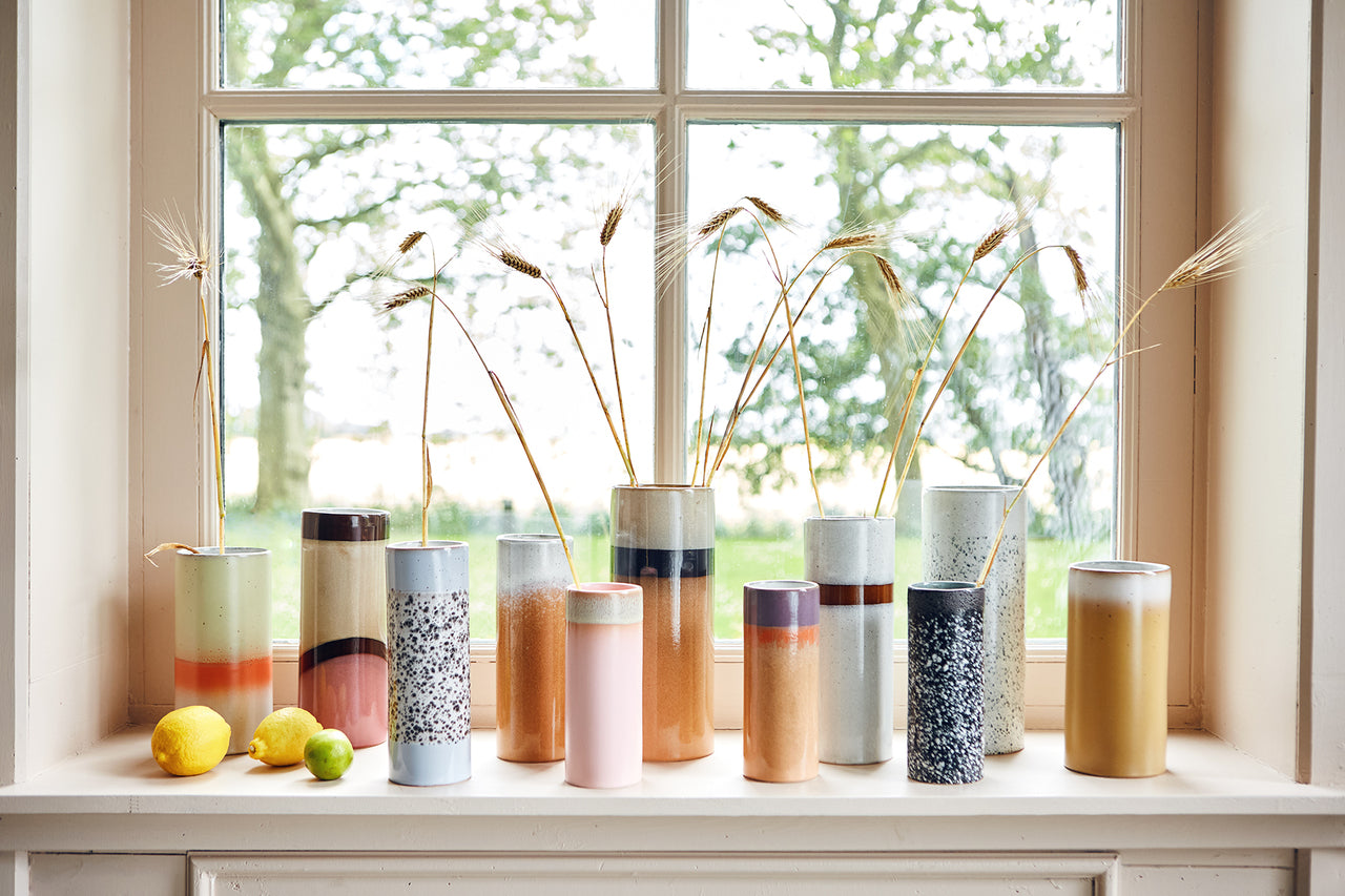 retro style flower vases in a row in a window