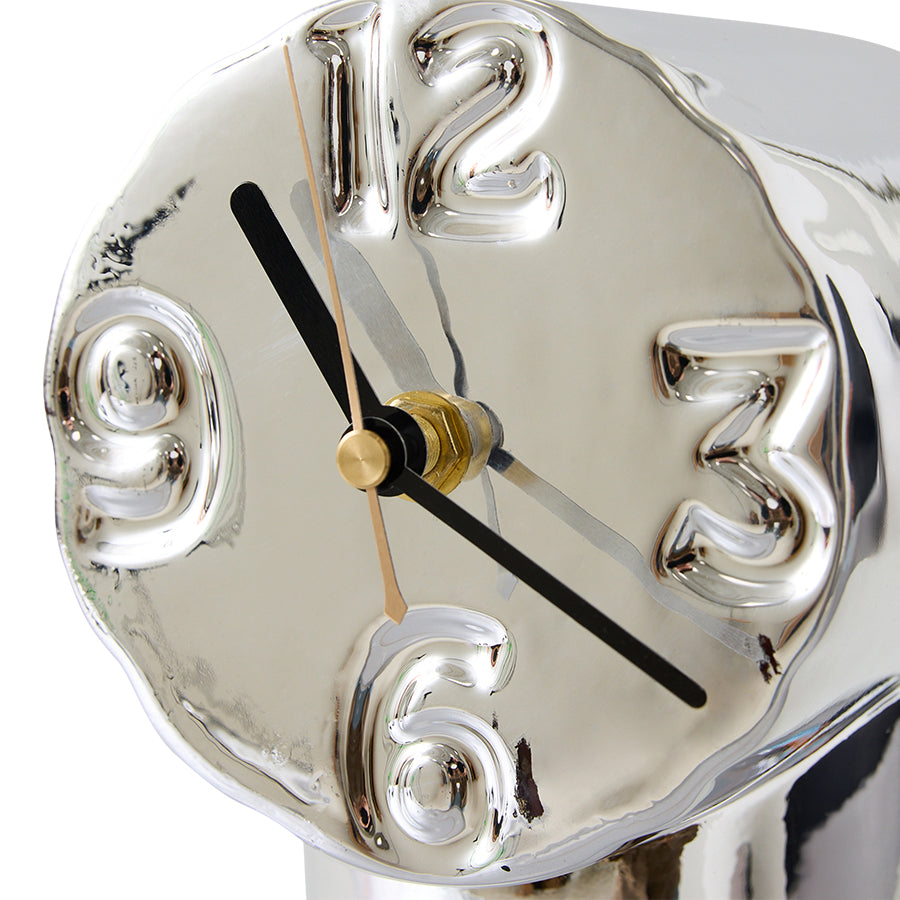 chrome colored ceramic clock with 4 numbers on a white background