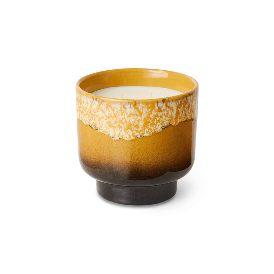 Ceramic candle in a brown and beige pot on a white background