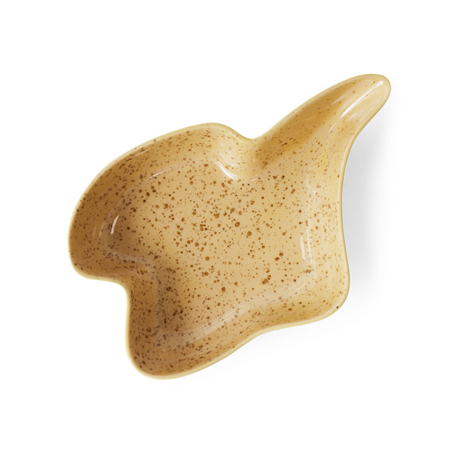 Beige ceramic dish with a unique shape on a white background