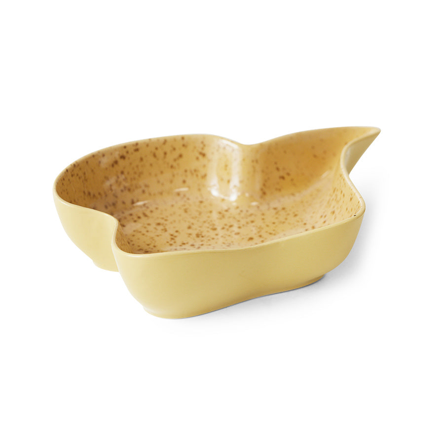 Speckled yellow ceramic bowl on a white background