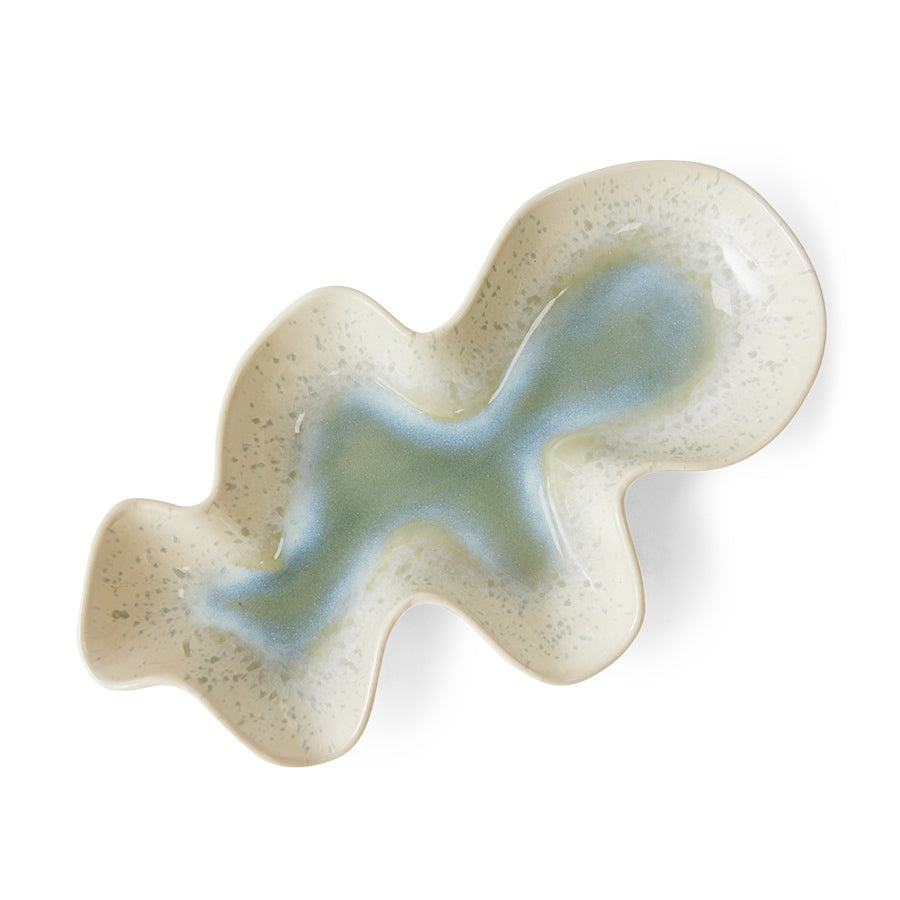Wavy ceramic dish with a textured surface on a white background