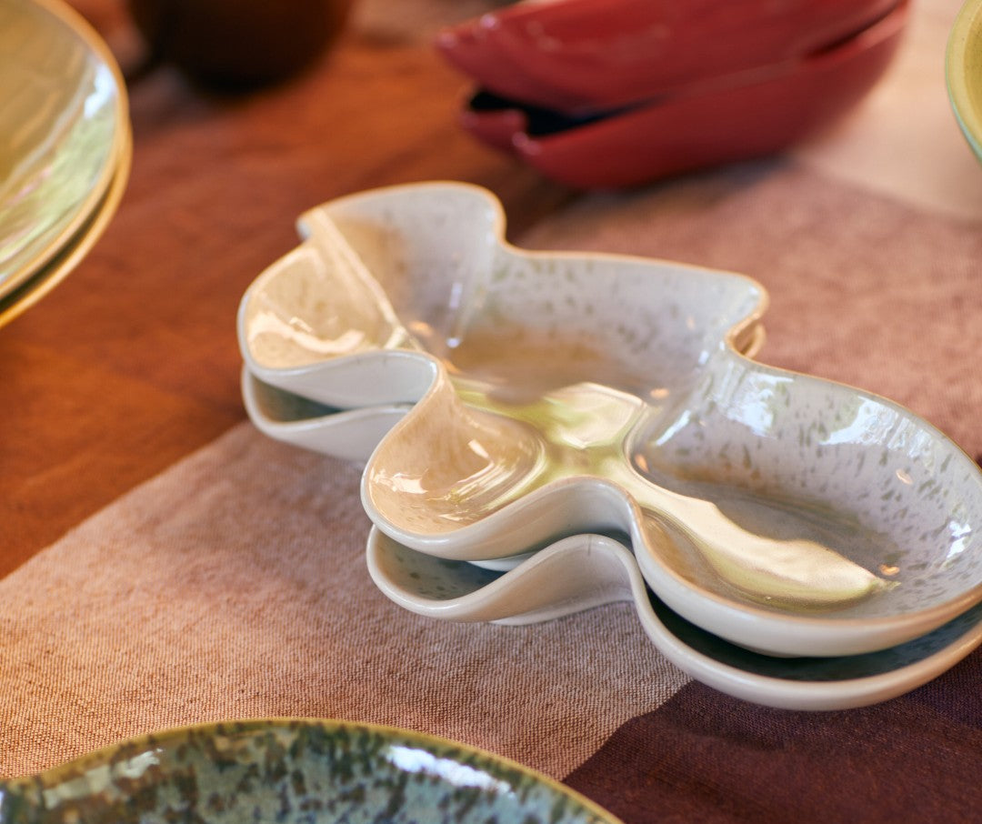 Ceramic dish with multiple compartments on a wooden surface