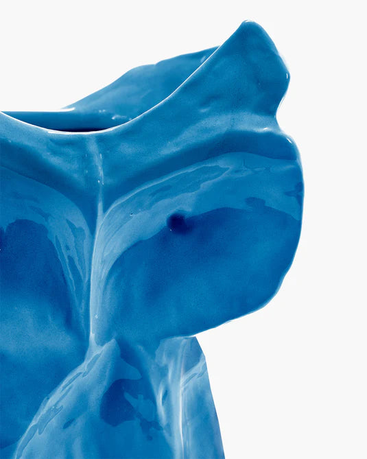 Blue ceramic vase with a smooth texture on a white background