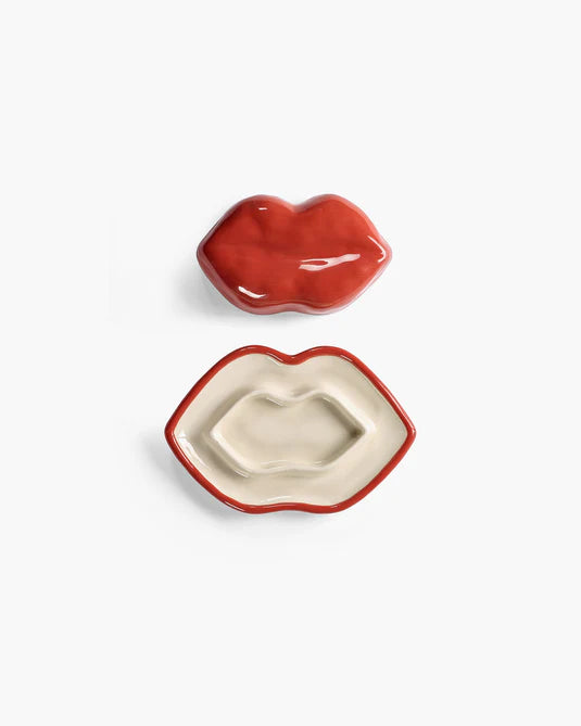 Two lip-shaped ceramic dishes on a white background