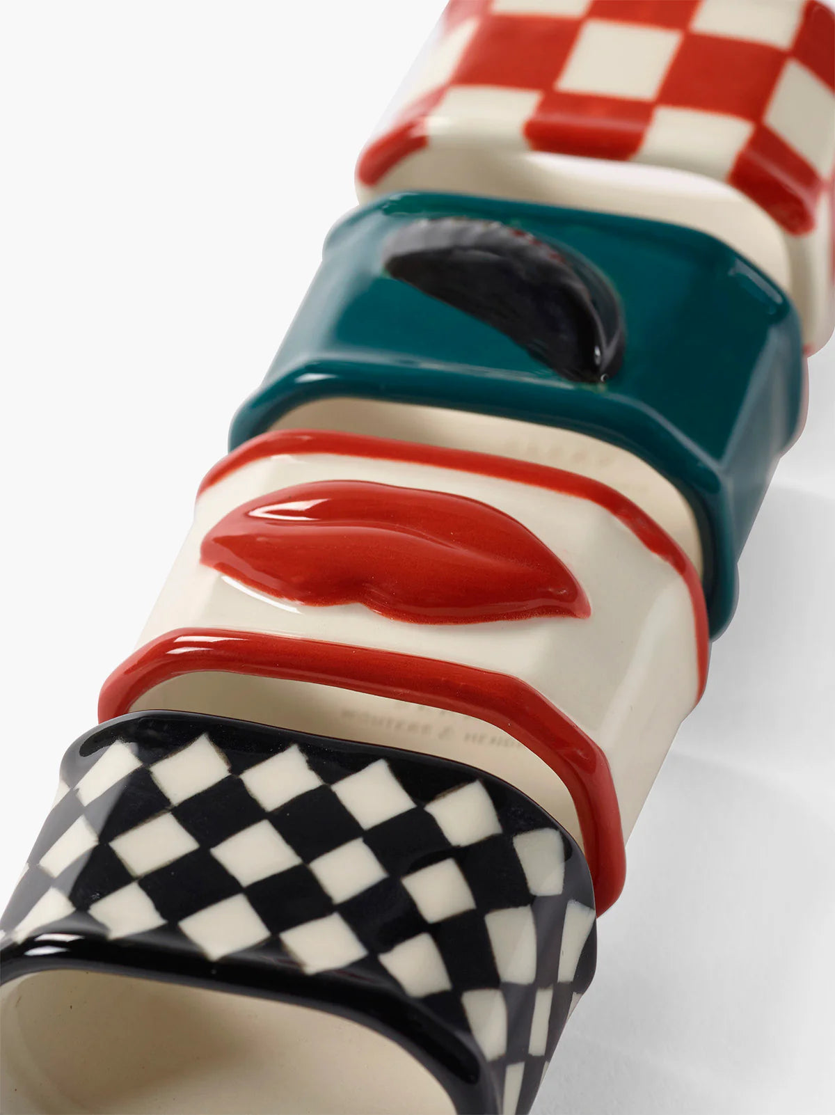Colorful ceramic object with checkered pattern on a white background