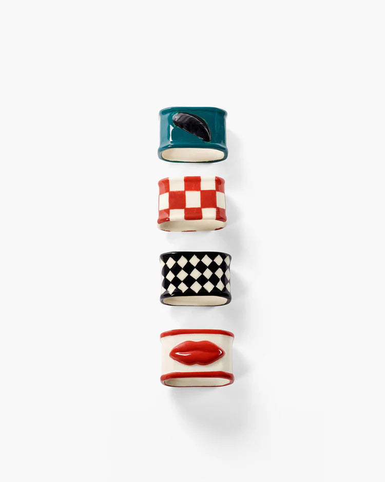 Set of five colorful ceramic napkin rings with patterned designs on a white background