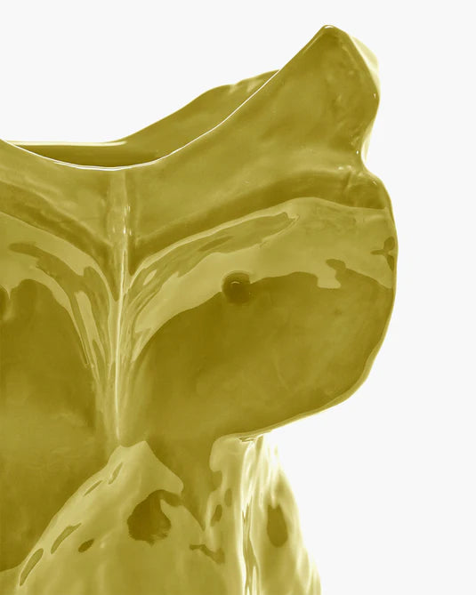 Yellow ceramic vase with a unique design on a white background