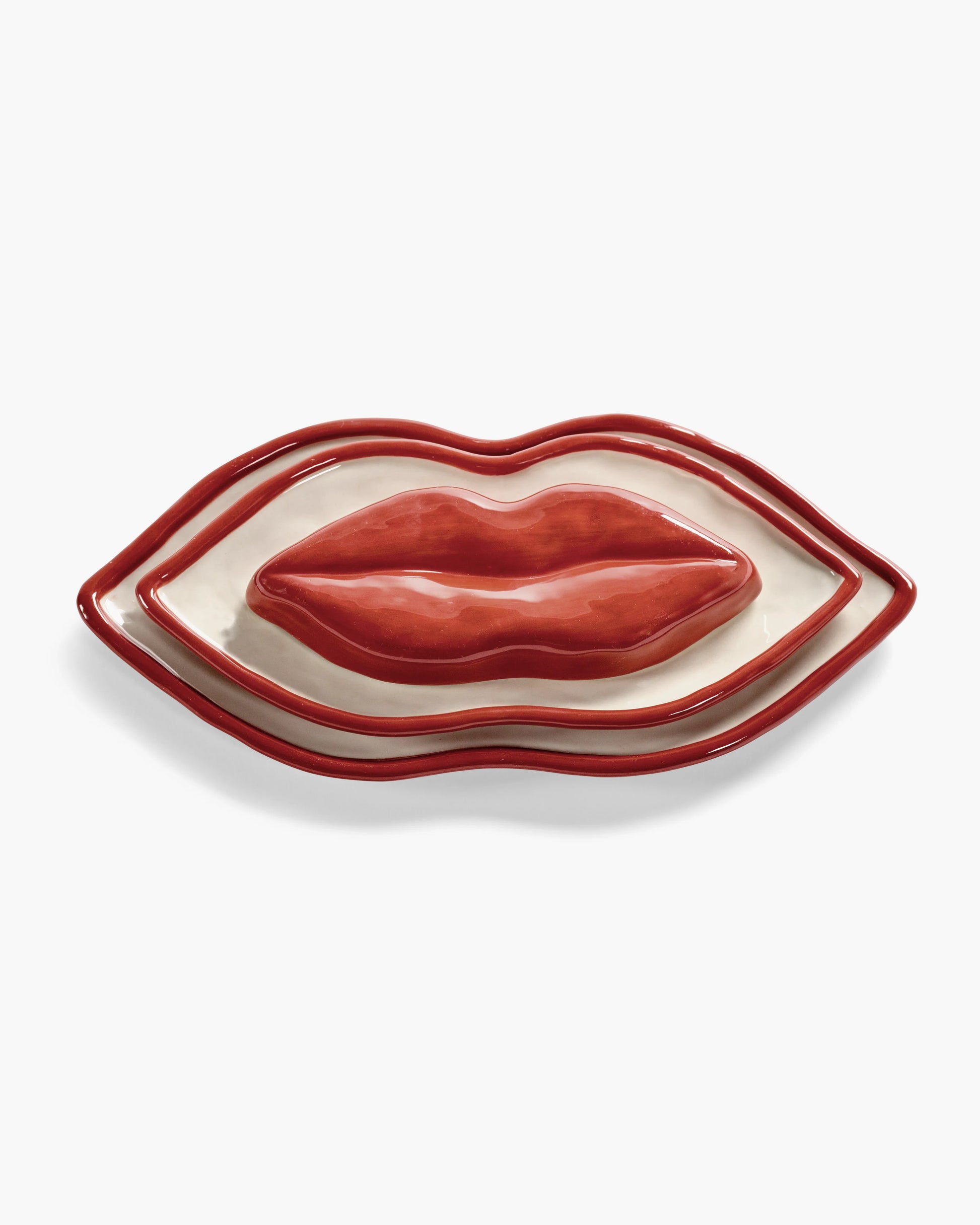 Lip-shaped ceramic dish on a white background