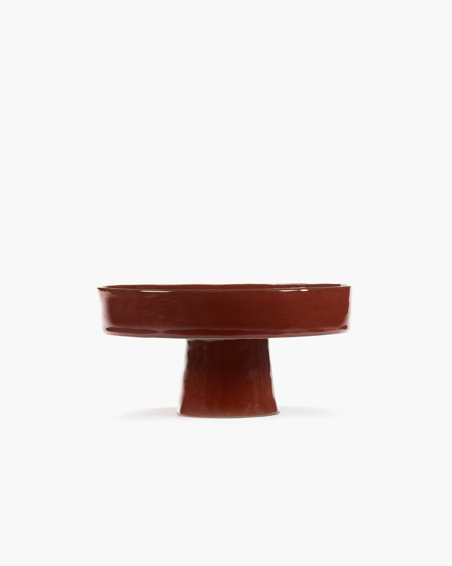 Brown ceramic pedestal dish on a white background